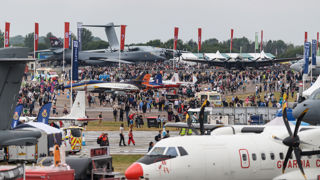 Busy showground at RIAT25 with crowds and static aircraft.