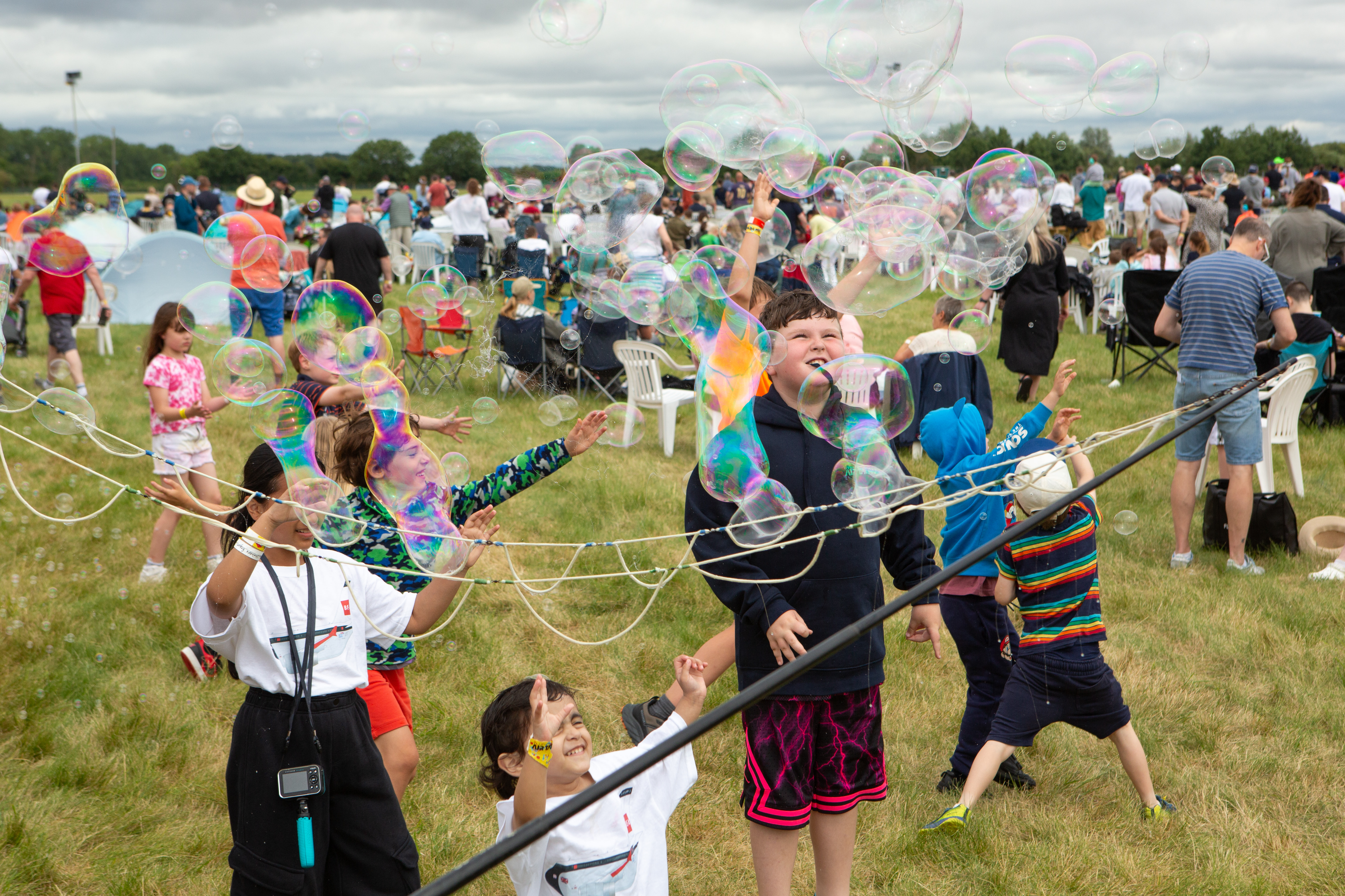 Children Playing With Bubbles In Family Enclosure RIAT24