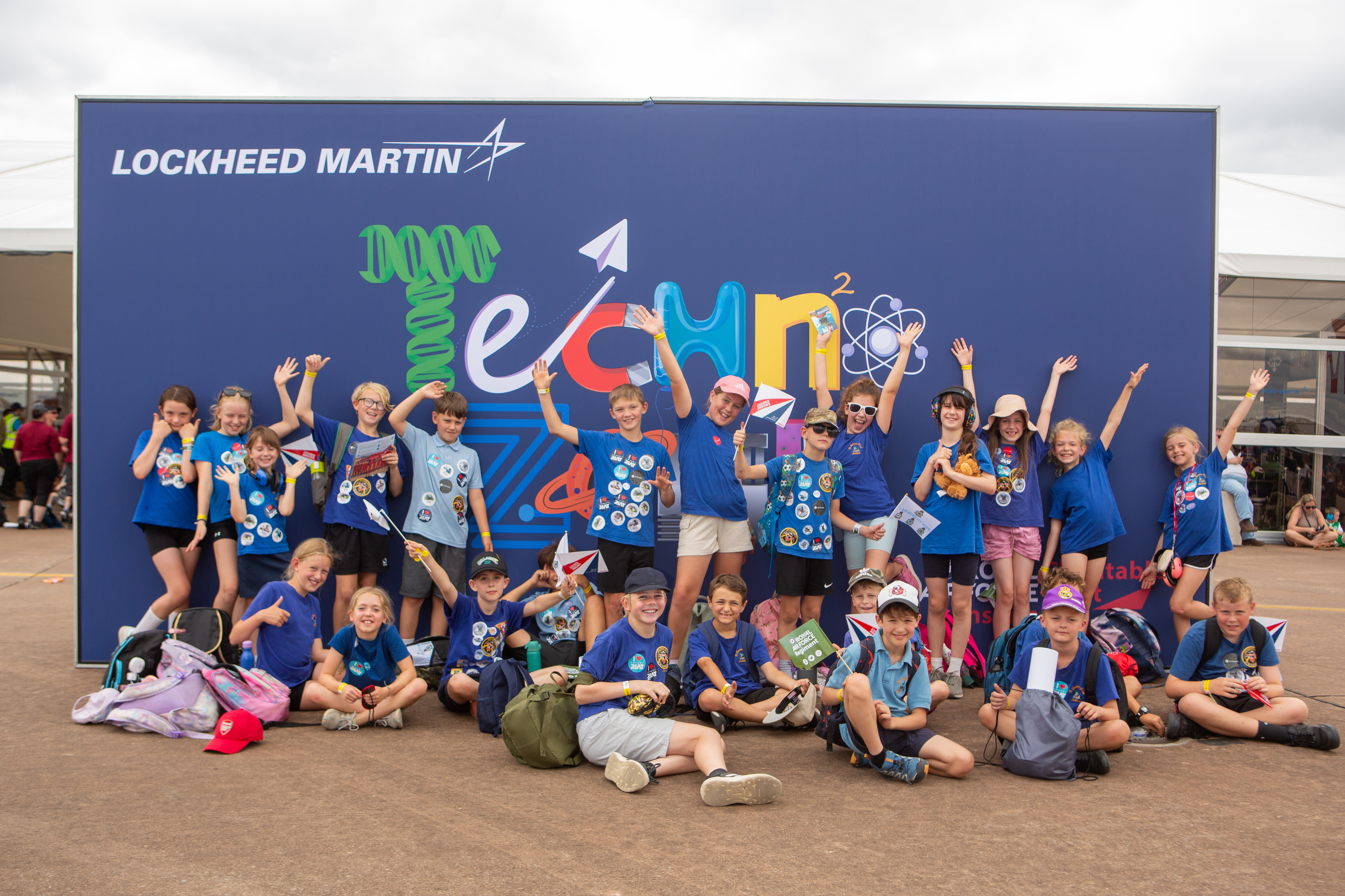Children sitting in front of the Techno Zone logo at RIAT25.