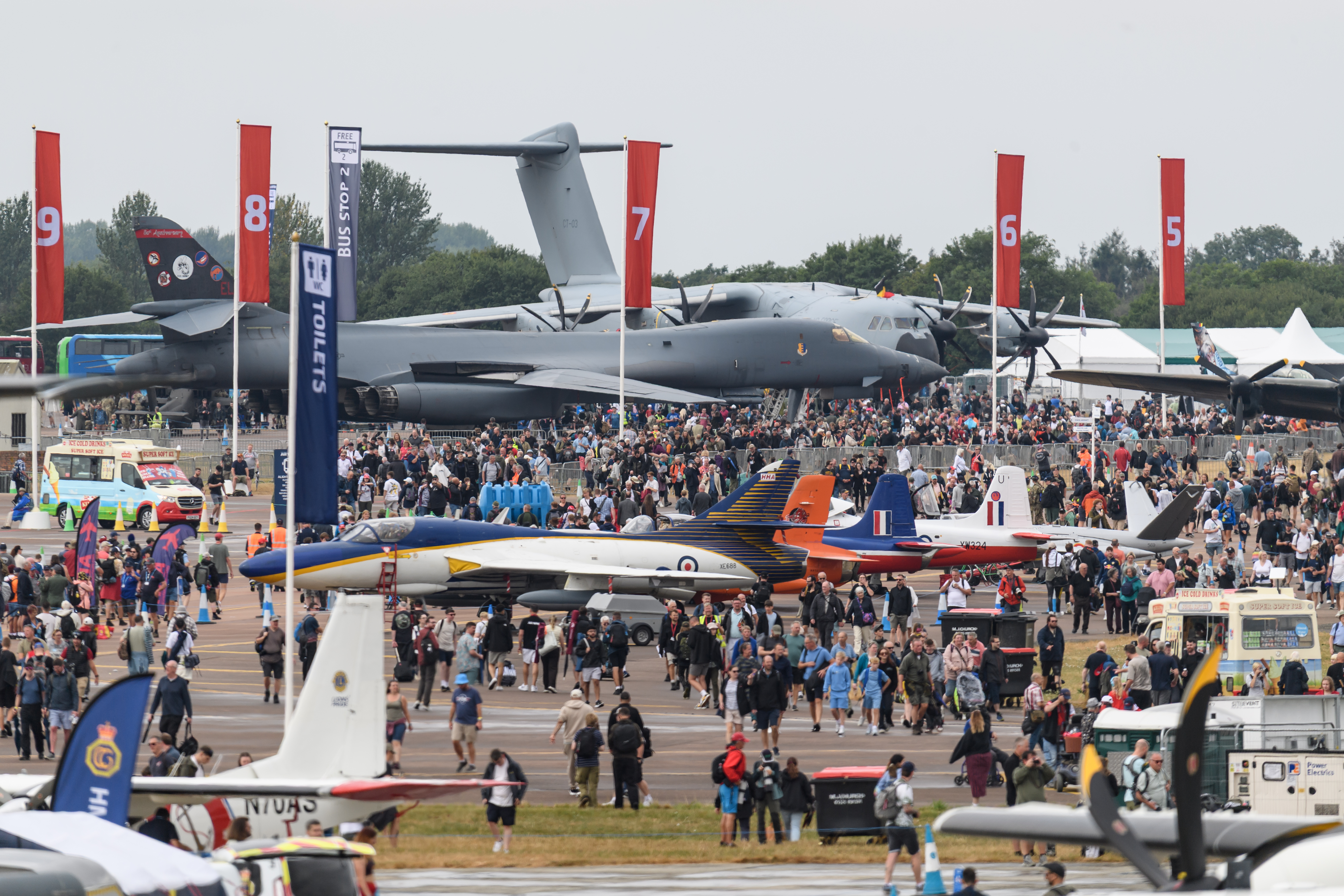 RIAT25 showground and crowds with static aircraft and flags.