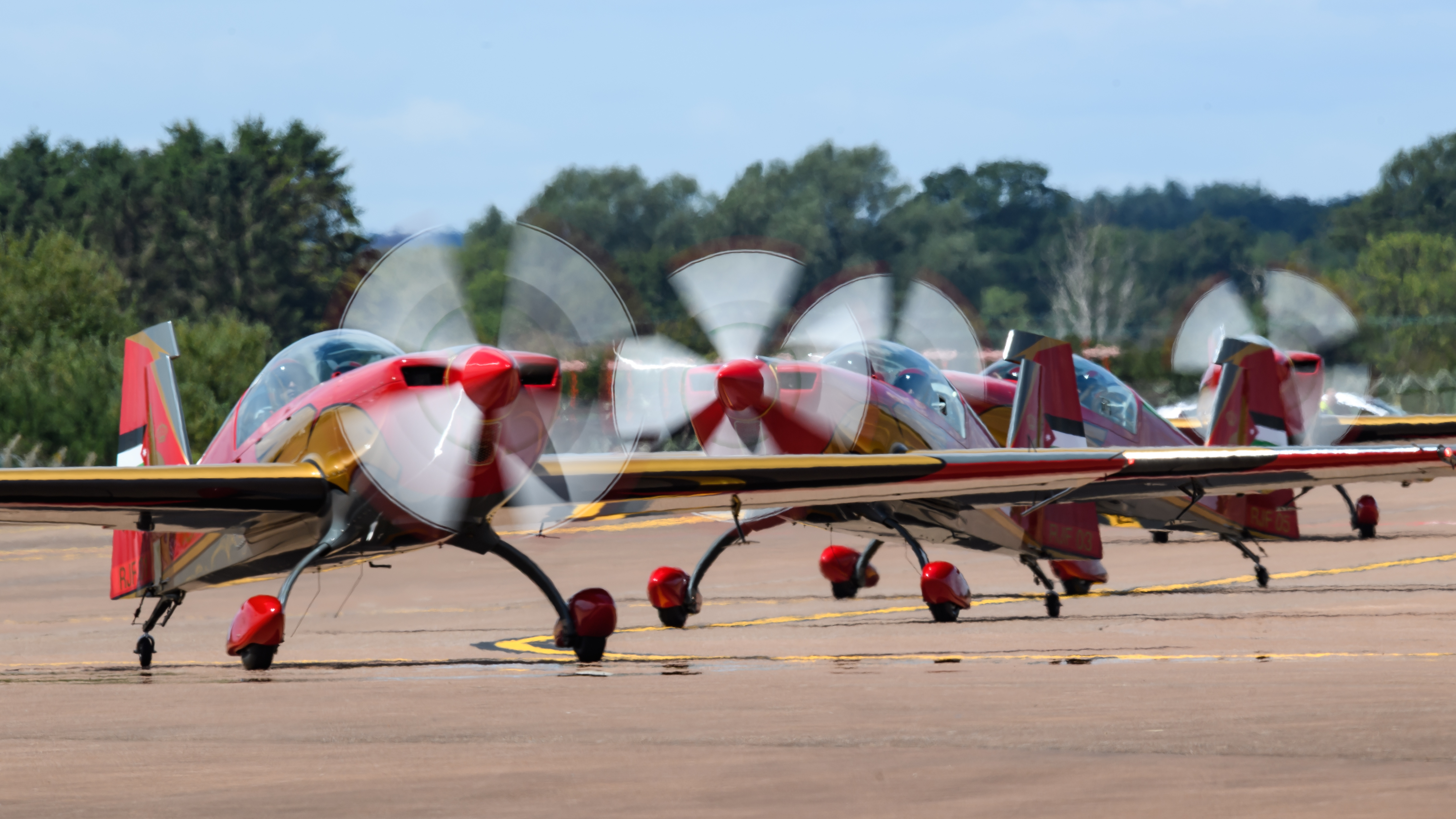 Three aircraft on runway with propellers spinning at RIAT25.