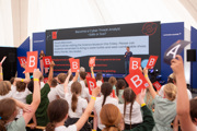 Pupils holding up the letter B in front of the Inspire stage on Friday Futures day at RIAT25.