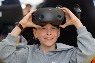 Boy with simulator headset for Power Up in the Techno Zone at RIAT25.