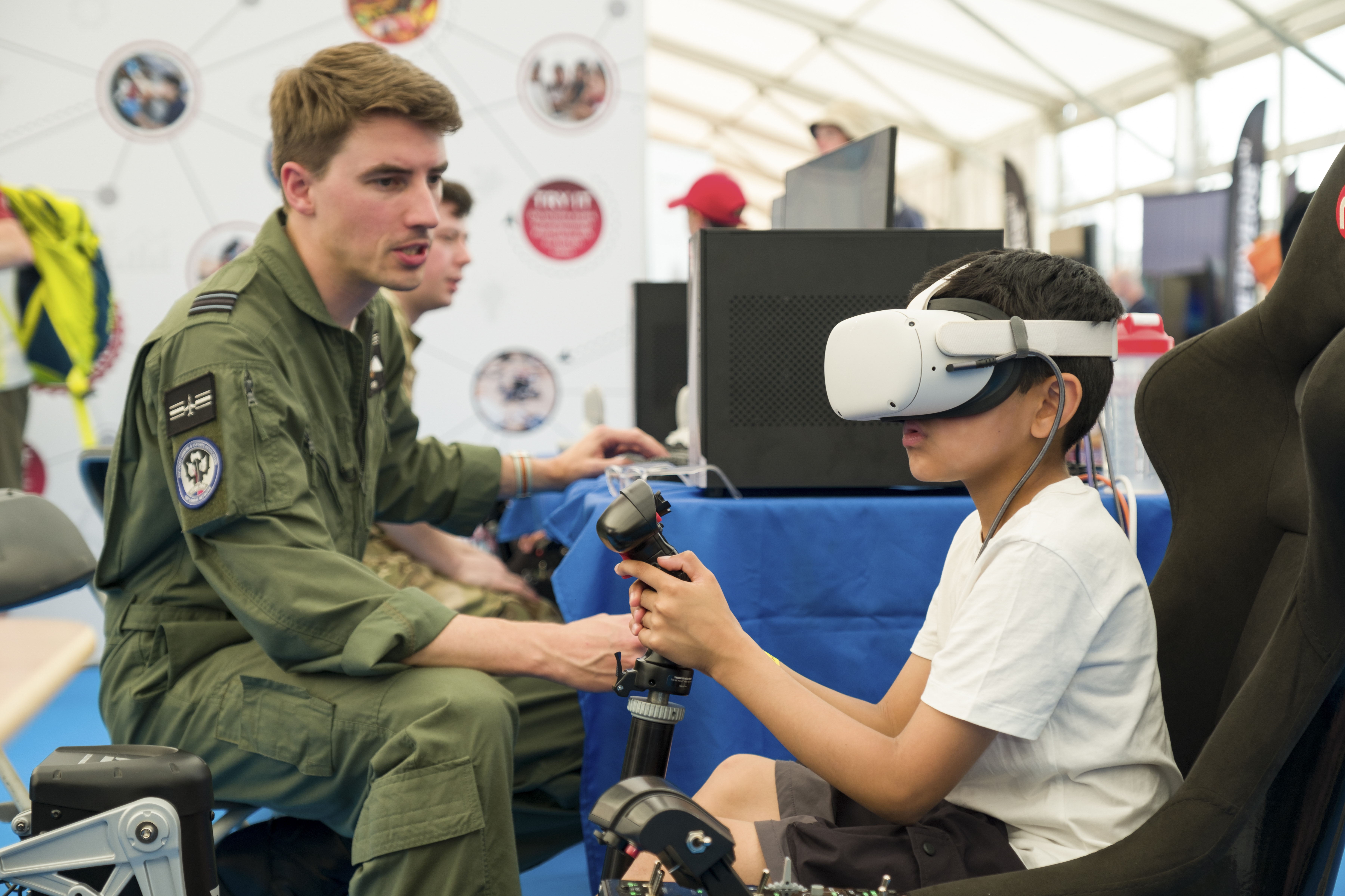Boy with simulator headset at the power up stand in the Techno Zone at RIAT25.